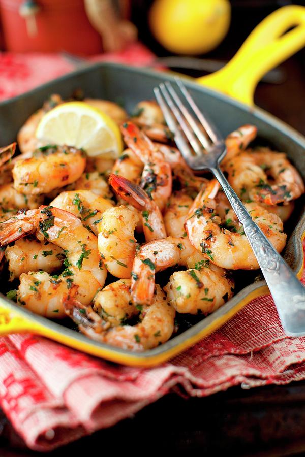 Garlic, Lemon And Parsley Shrimp In An Iron Skillet With A Fork Photograph by Strokin, Yelena
