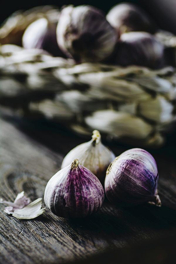 Garlic On A Wooden Surface Photograph by Mateusz Siuta