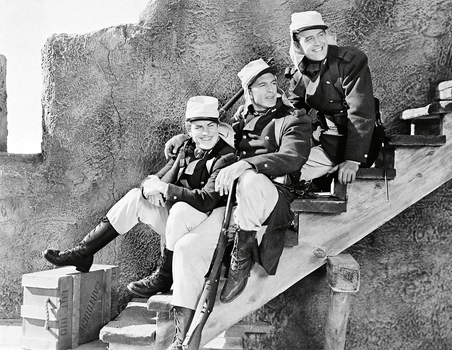 GARY COOPER , RAY MILLAND and ROBERT PRESTON in BEAU GESTE -1939-. Photograph by Album