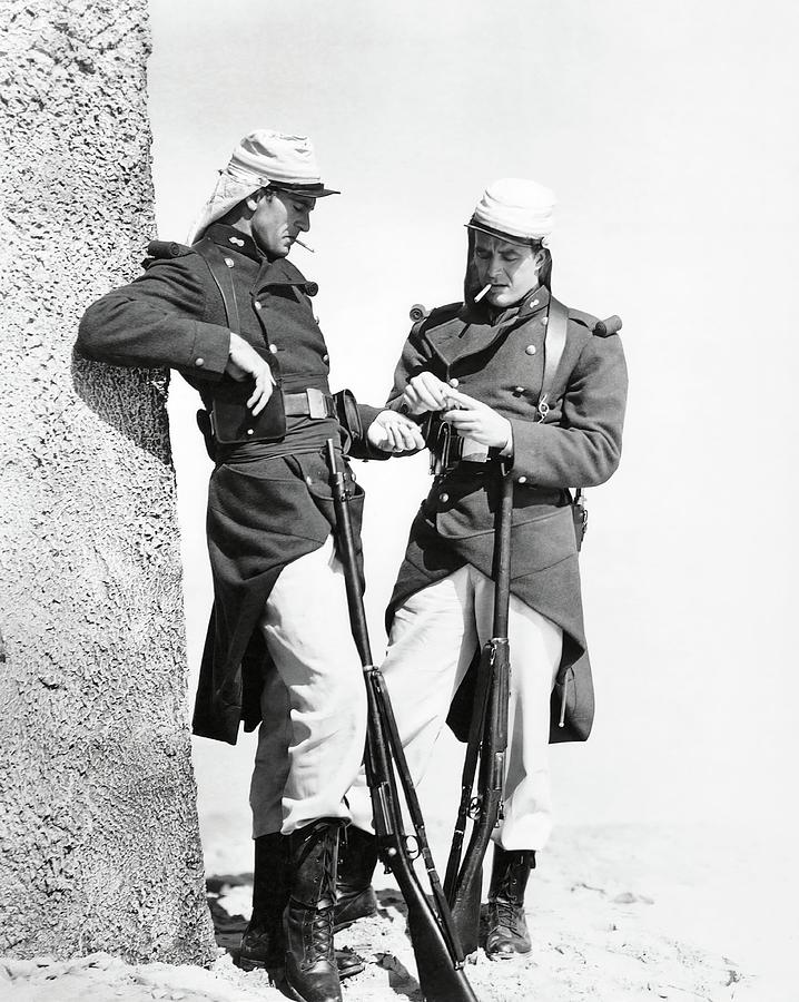 GARY COOPER and RAY MILLAND in BEAU GESTE -1939-. Photograph by Album