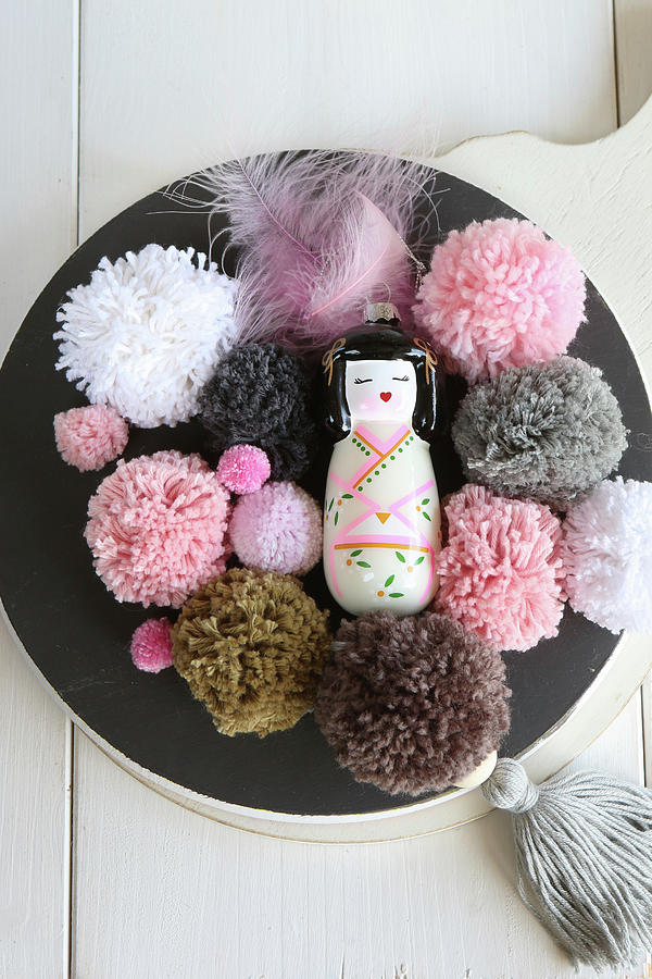 Geisha Figurine And Pompoms In Pink And Earthy Tones On Black Plate Photograph by Regina Hippel
