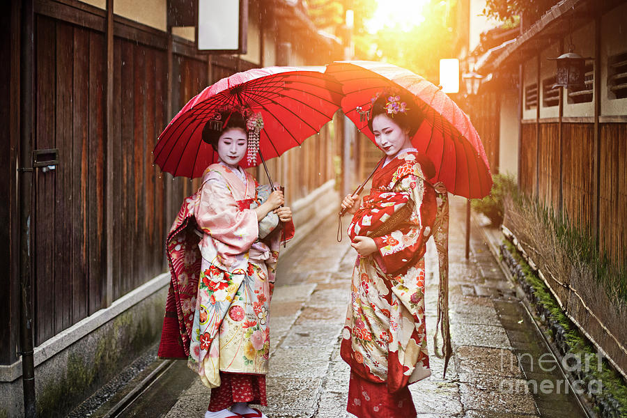 Geisha Girls Holding Red Umbrellas Photograph by Xavierarnau