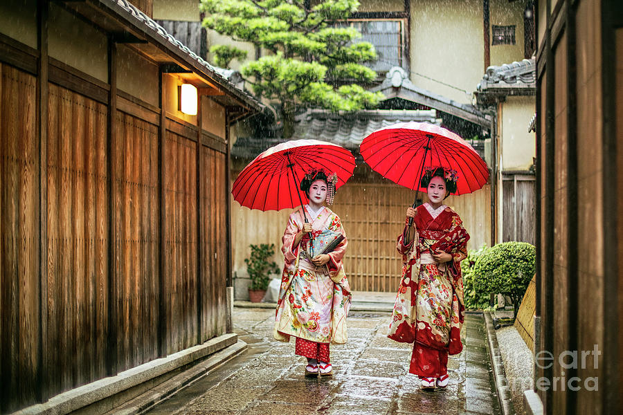 Geishas Holding Red Umbrellas Photograph by Xavierarnau