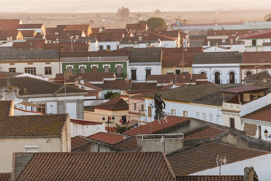 General View Of The Roofs Of The Town Of Medellin With The Statue Of Hernan Cortes Standing Over Them, Extremadura, Spain. Photograph