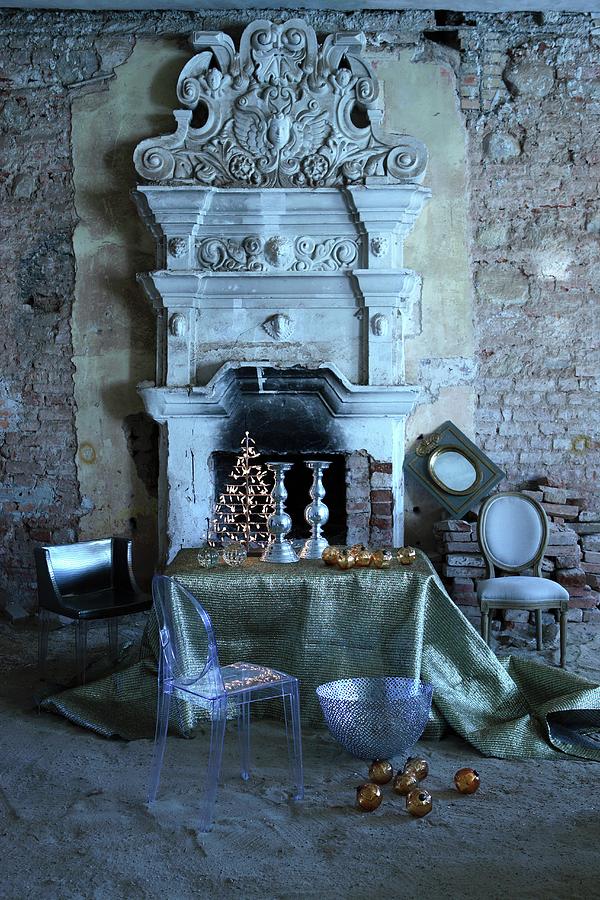 Ghost Chair And Christmas Arrangement On Table In Front Of Open Fireplace With Greek-style, Antique Architectural Elements In Dilapidated Ambiance Photograph by Michal Mrowiec