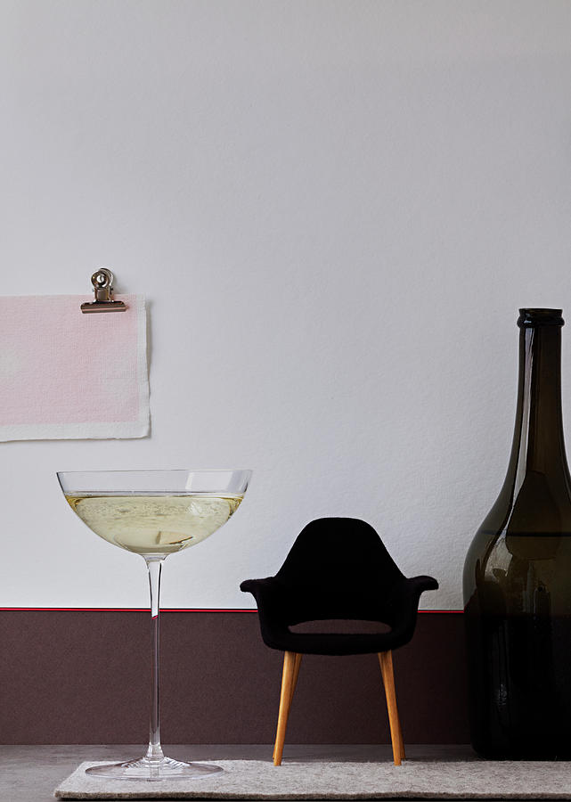 Giant Glass And Bottle Of Champagne With A Miniature Designers Armchair Photograph by Japy