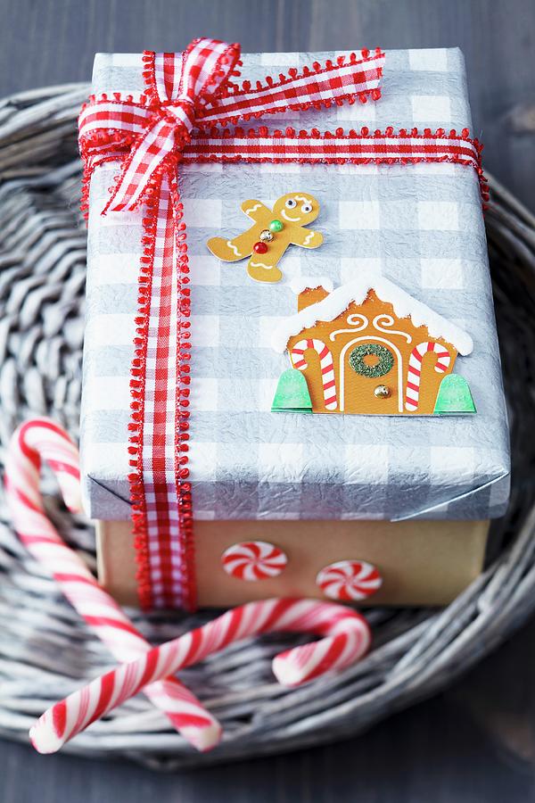 Gift Box Festively Decorated With Gingerbread Stickers, Red And White Checked Ribbon And Candy Canes Photograph by Franziska Taube