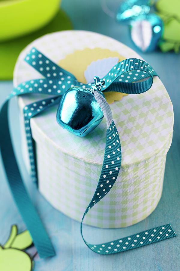 Gift Box With Apple Bauble And Polka-dot Ribbon Photograph by Franziska Taube