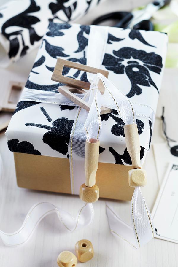 Gift Box With White Ribbon Threaded With Wooden Beads Photograph by Franziska Taube
