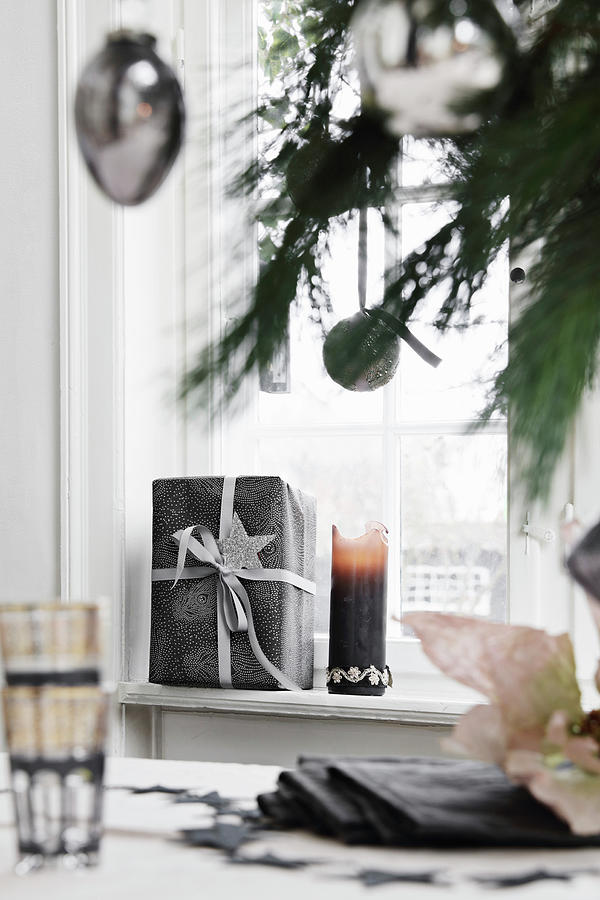 Gifts And Candle On Windowsill Photograph by Lykke Foged & Morten Holtum