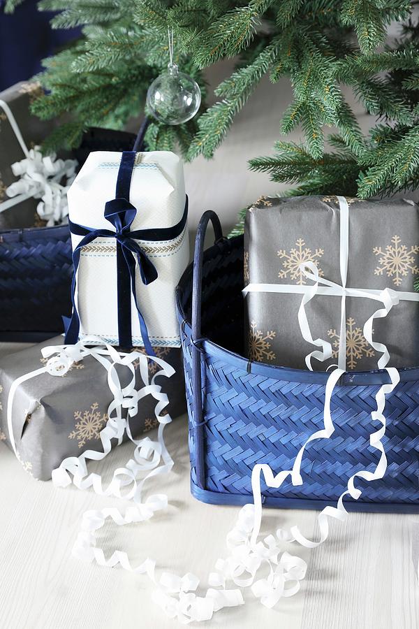 Gifts In Blue Baskets Below Christmas Tree Photograph by Annette Nordstrom