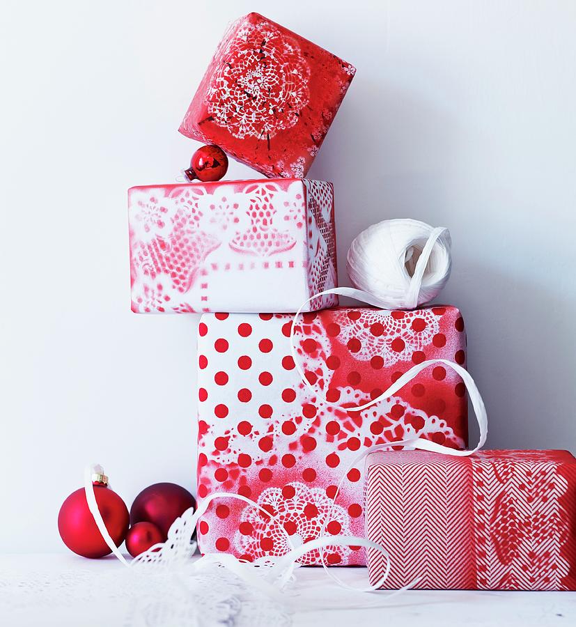 Gifts Wrapped In Hand-made Paper With Different Patterns Of Red And White Photograph by Andreas Hoernisch