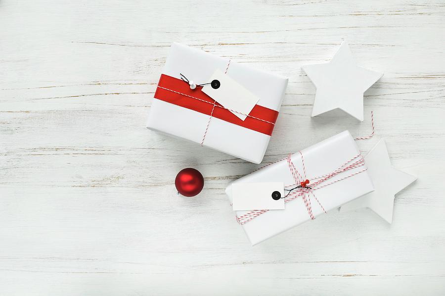 Gifts Wrapped In Red And White With Tags And Two Stars Photograph by Achim Sass