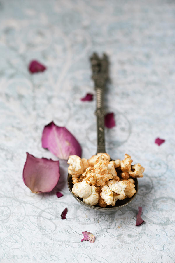 Gilded Popcorn On A Vintage Spoon Next To Rose Petals Photograph by Mandy Reschke