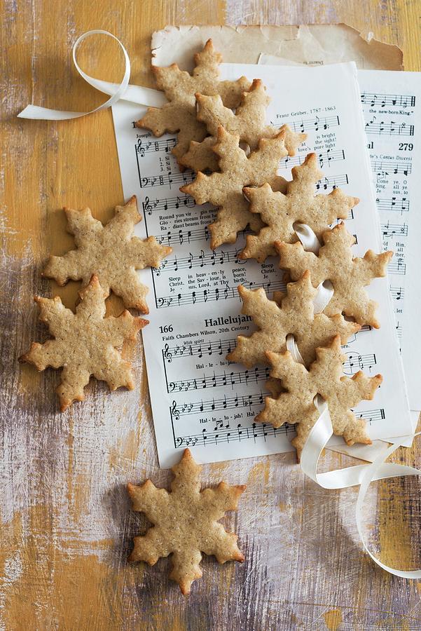 Gingerbread Biscuits On Sheet Music Photograph by Veronika Studer