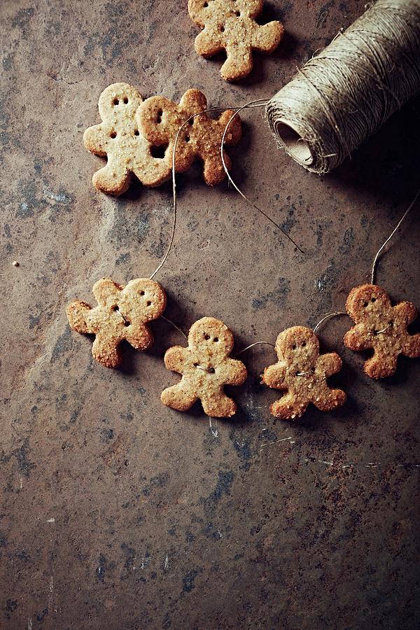Gingerbread Man Cookies On A String Photograph by B.&.e.dudzinski