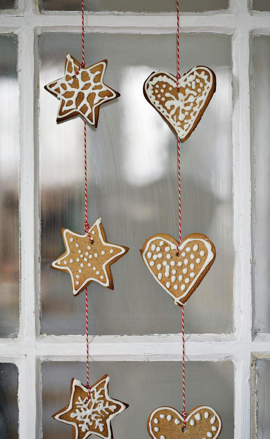 Gingerbread Shapes Threaded On String Hung In Window Photograph by Lykke Foged & Morten Holtum