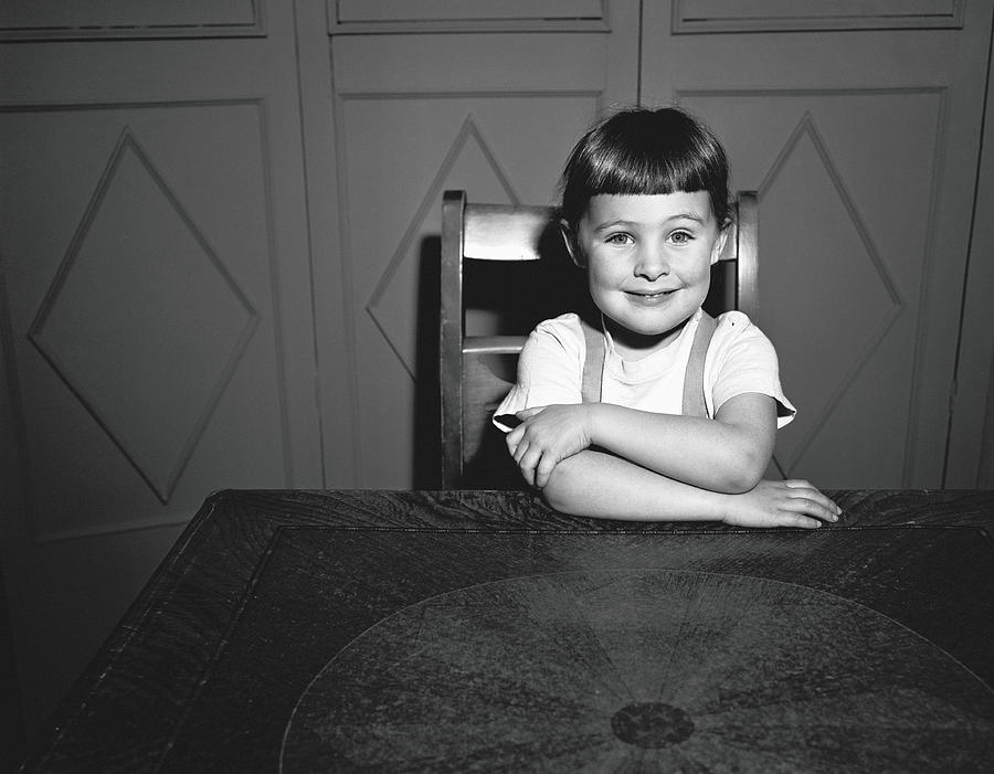 Girl 5-5 Sitting At Table, B&w, Portrait Photograph by George Marks