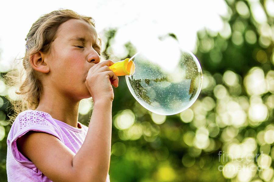 girl blowing bubbles