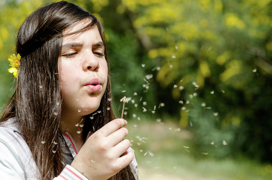 Girl blowing dandelion flower Photograph by Michalakis Ppalis