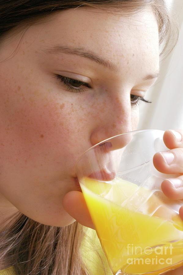 Girl Drinking Orange Juice Photograph by Aj Photo/science Photo Library