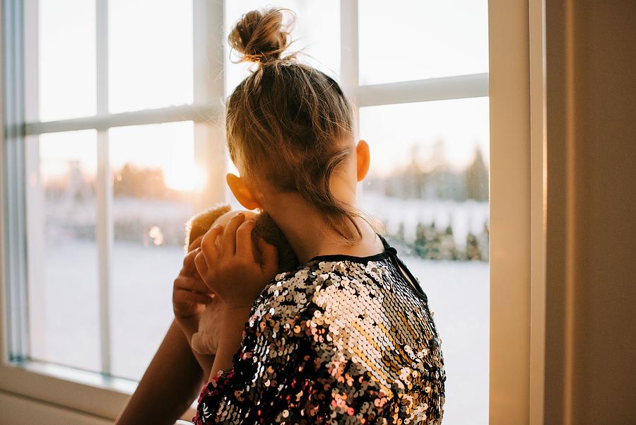 Sunset Photograph - Girl Looking Out A Window In A Sparkly Dress Watching The Sun Go Down by Cavan Images