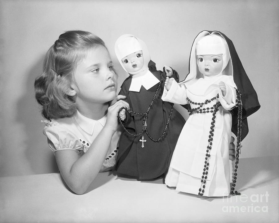 Girl Playing With Nun Dolls Photograph by Bettmann