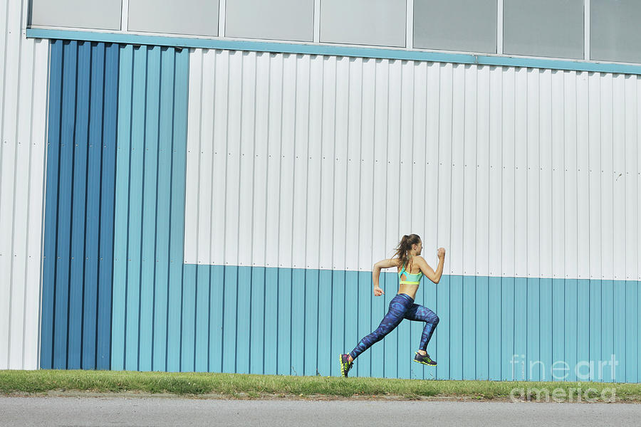 Girl Running On Grass Against Blue Photograph by Stanislaw Pytel