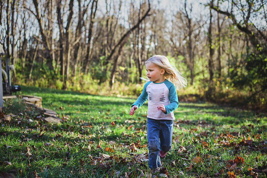 Girl Running On Grassy Field At Park During Autumn Photograph by Cavan ...