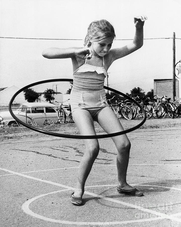 Girl Twirling Hula Hoop Photograph by Bettmann