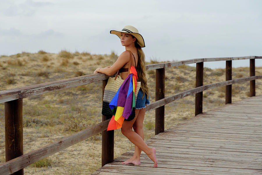 Girl Walks Outdoors With The Lgbt Flag In Her Bag For Gay Pride Day Photograph By Cavan Images