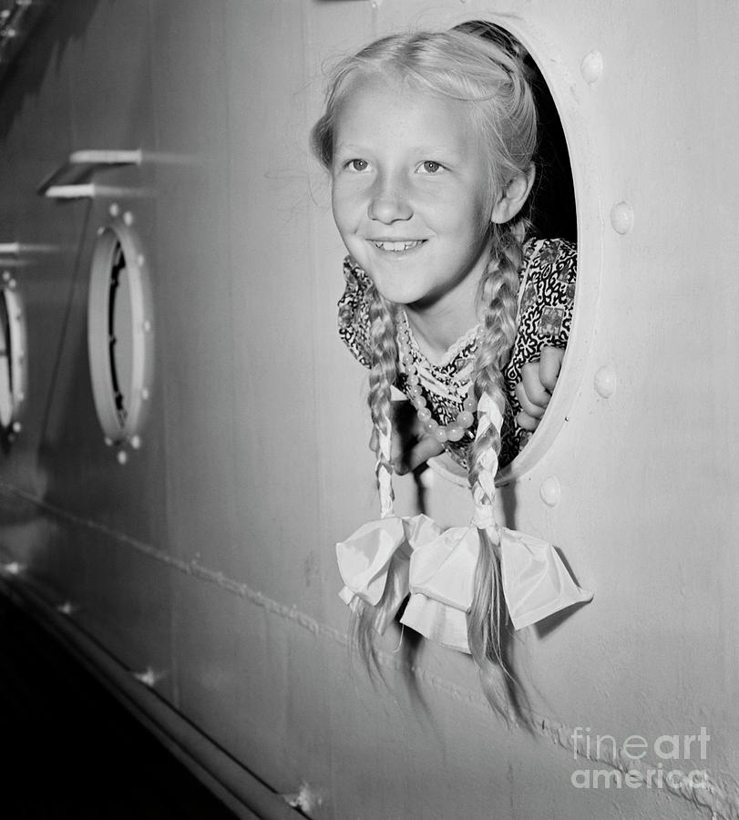 Girl With Her Head Out Of Porthole Photograph by Bettmann