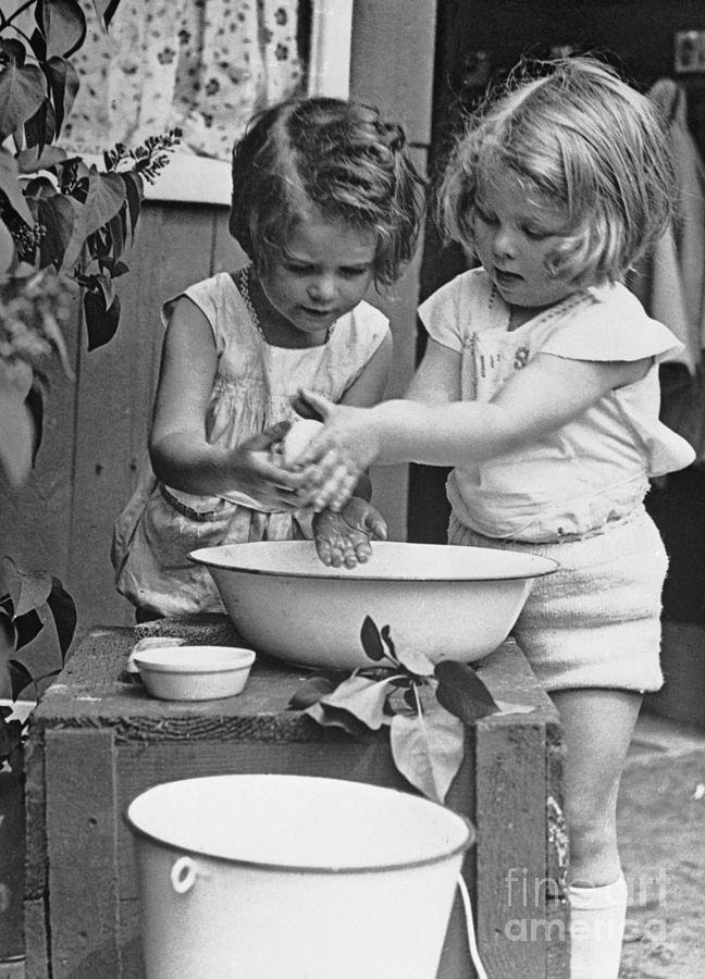 Girls 6-7 Washing Hands In Wash Bowl by Bettmann