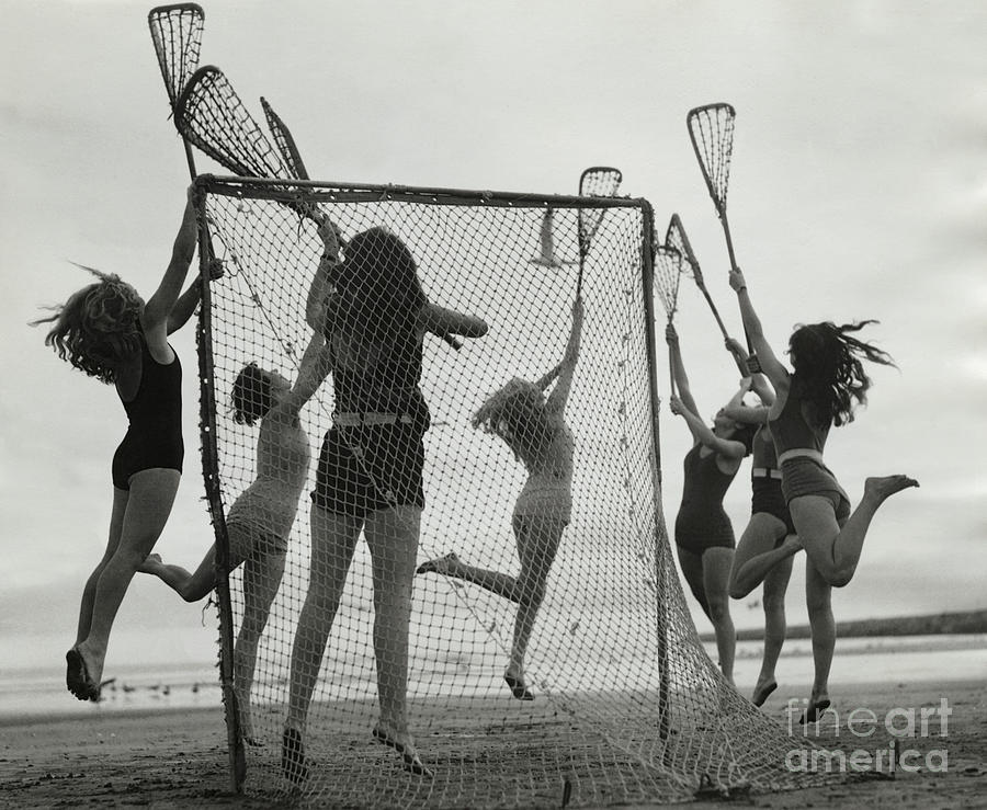 Girls Playing La Crosse On Beach Photograph by Bettmann
