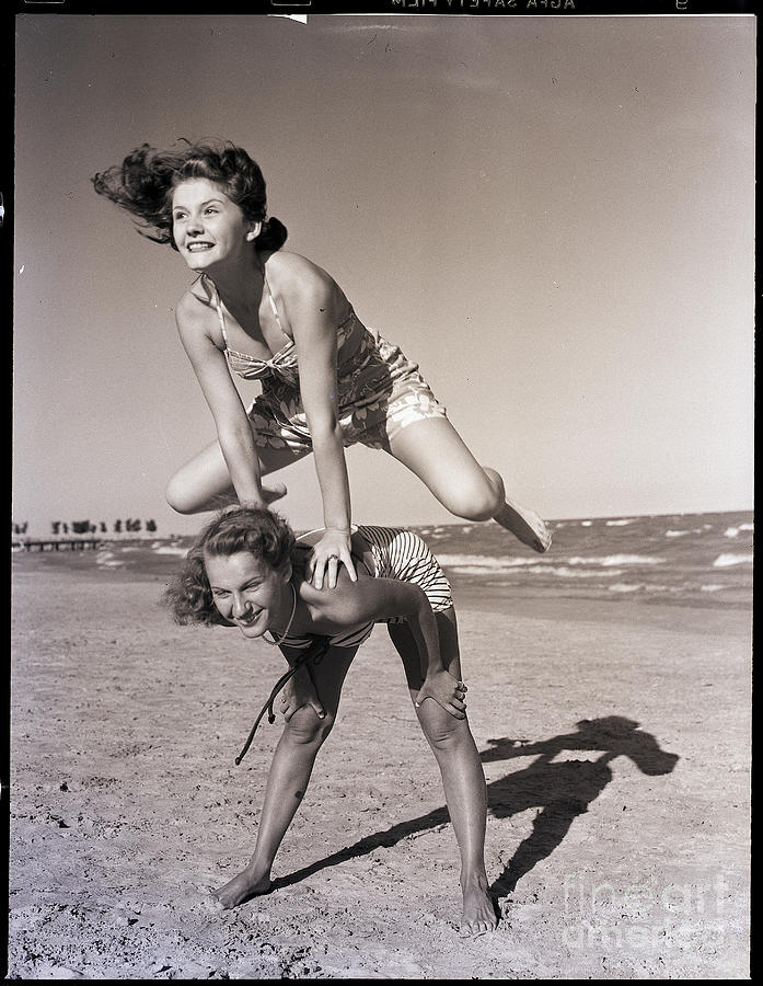 Girls Playing Leapfrog On Beach Photograph by Bettmann