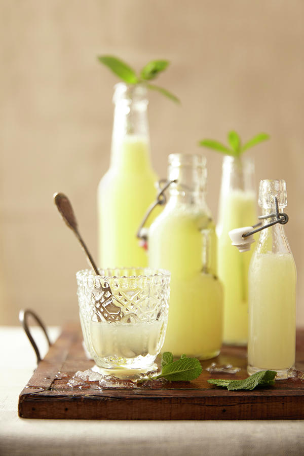 Glass And Bottles Of Homemade Lemonade Photograph by Lukam