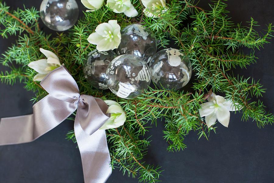 Glass Christmas-tree Baubles, Green Conifer Branches, Hellebore Flowers And Satin Ribbon Photograph by Alicja Koll