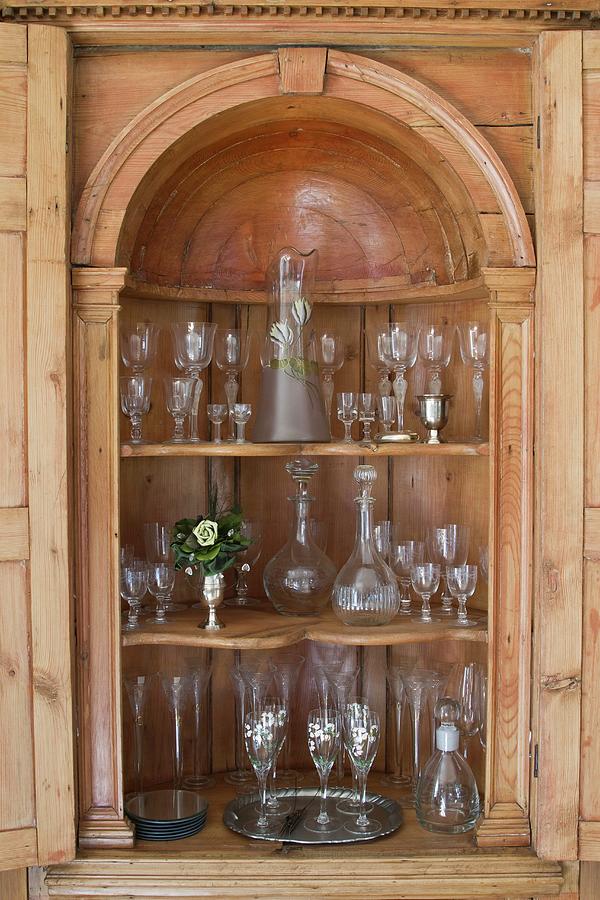 Glass Collection In Ornately Carved Cabinet With Rounded Arch Photograph by Catja Vedder