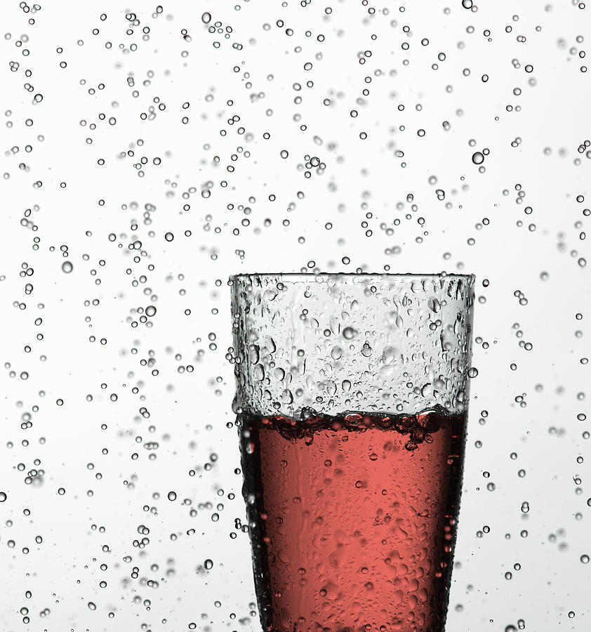 Glass Of Juice In Water Drops Photograph by Walter Zerla