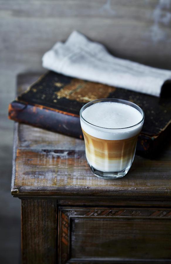 Glass Of Latte Macchiato Coffee On Old Cabinet Photograph by B.&.e.dudzinski