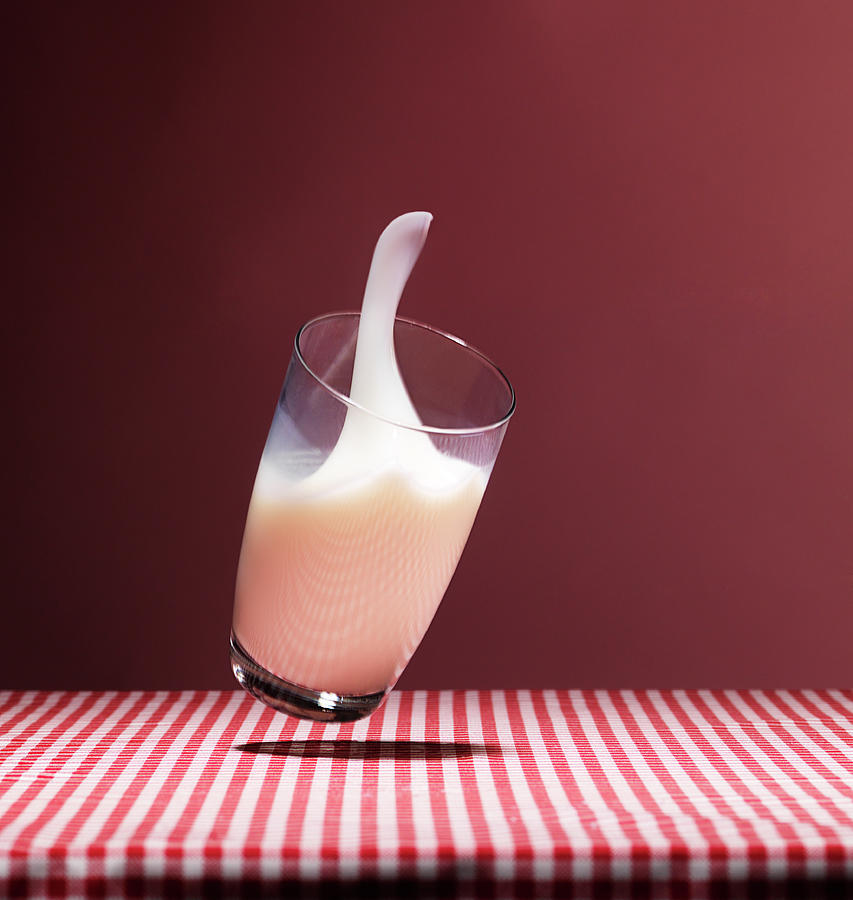 Glass Of Milk Falling On Table Photograph by Henrik Sorensen