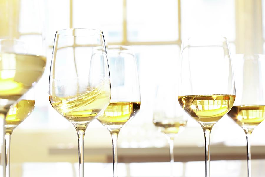Glass Of White Wine In Front Of A Window Photograph by Jalag / Gtz Wrage