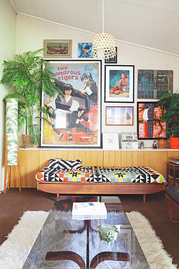 Glass-topped Coffee Table And Couch With Ethnic Blanket Against Half-height, Continuous Sideboard Below Collection Of Pictures On Wall Photograph by Natalie Jeffcott