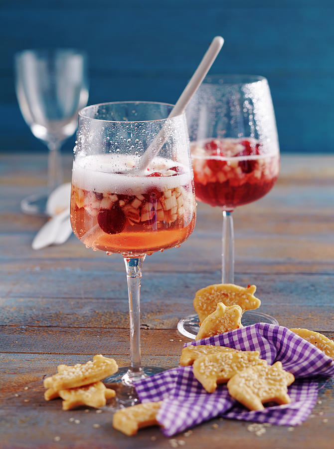 Glasses Of Fruity New Years Eve Punch With Prosecco And Cranberries With Spicy Pig-shaped Biscuits Photograph by Teubner Foodfoto