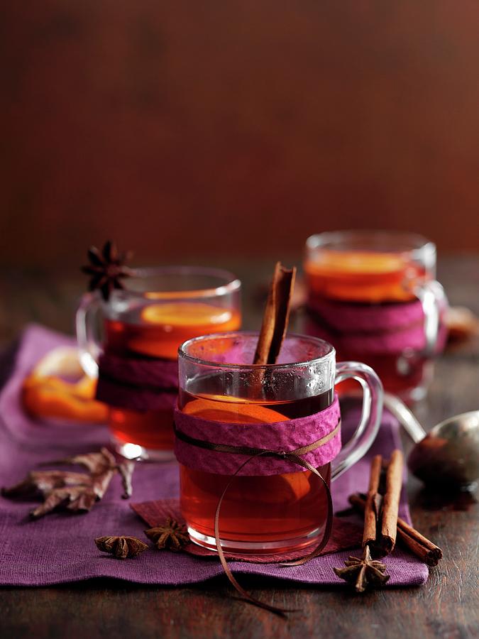 Glasses Of Mulled Wine With Cinnamon, Anise And Orange Slices Photograph by Gareth Morgans
