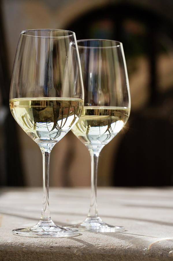 Glasses Of White Wine On Table Photograph by Foodcollection Rf