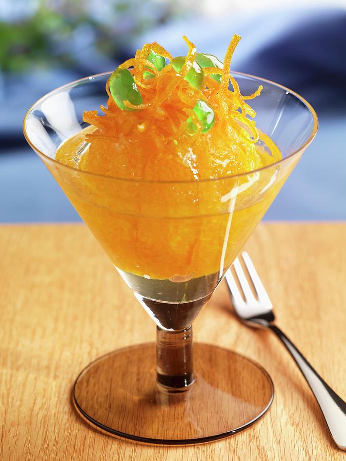Glazed Orange Topped With Candied Orange Zest And Candied Green Cherries; In A Stem Glass Photograph by Paul Poplis