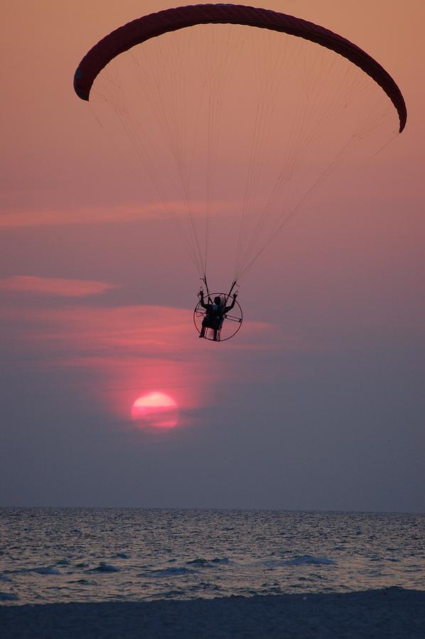 Glider over the ocean at sunset Photograph by Dennis Schmidt