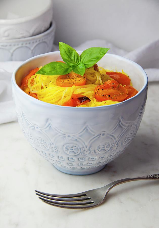 Glutenfree Capellini Pasta With Roasted Tomatoes And Basil In A Bowl