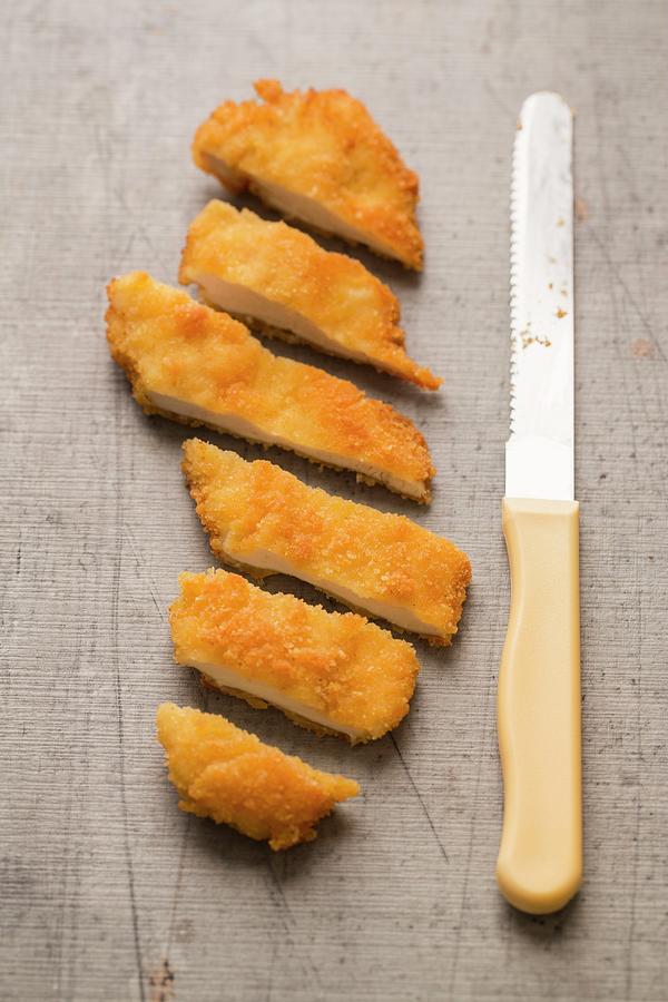 Gluten-free Chicken Escalope In Breadcrumbs, Cut Into Slices Photograph by Sandra Krimshandl-tauscher